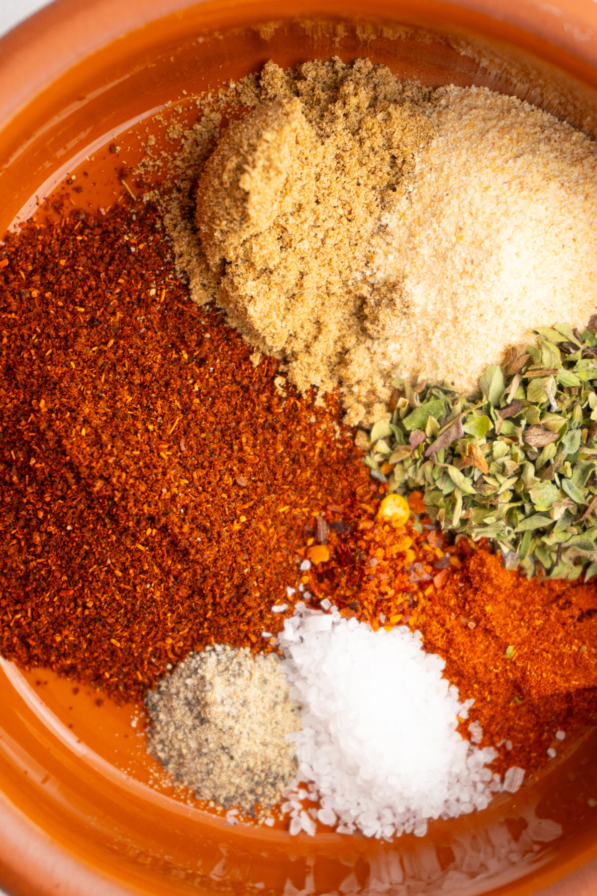 Close up of homemade DIY taco seasoning in a bowl before mixing the spices.