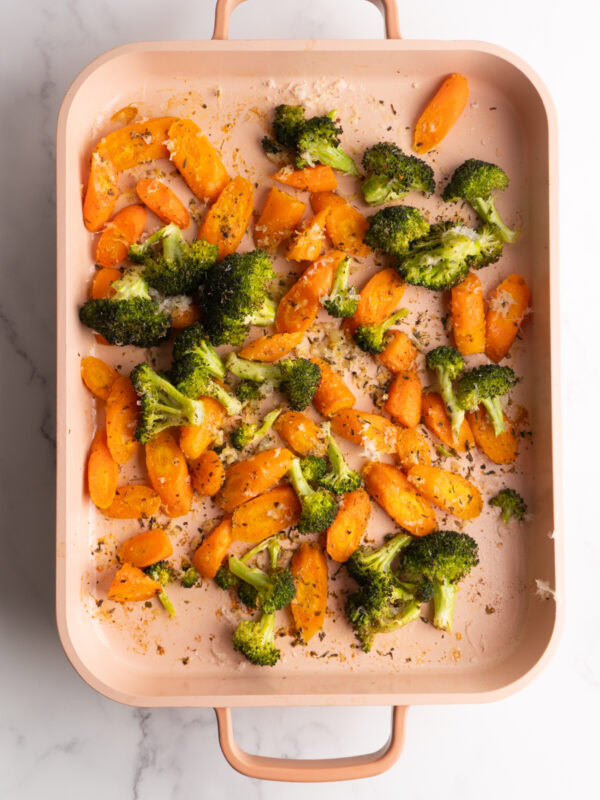 Finished roasted carrots and broccoli on a sheet pan.