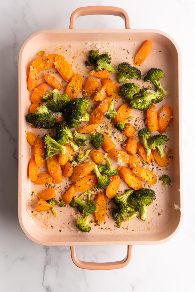 Finished roasted carrots and broccoli on a sheet pan.
