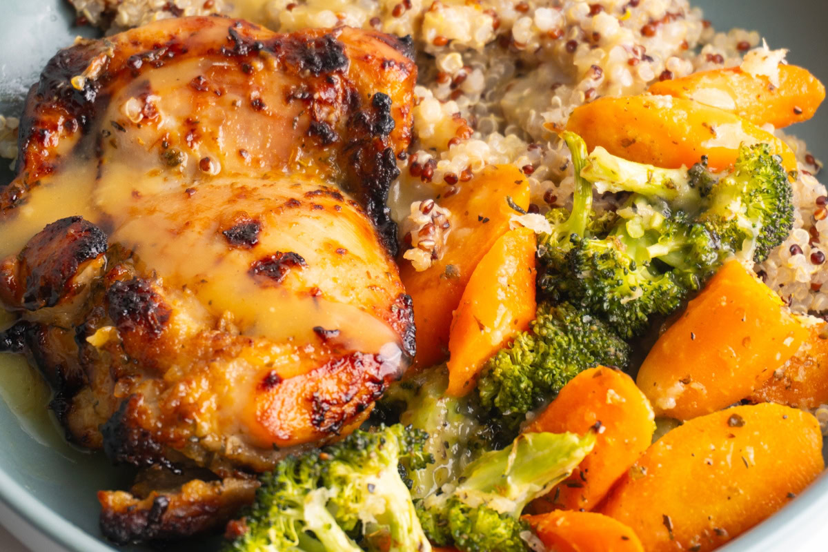 Close up of honey mustard chicken with quinoa and roasted veggies.