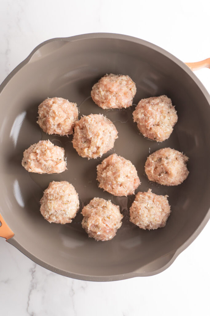 Marry me chicken meatballs in a skillet with oil.