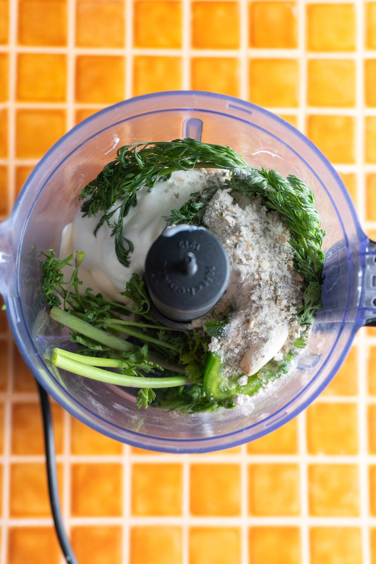 Ingredients for cilantro ranch in a food processor.