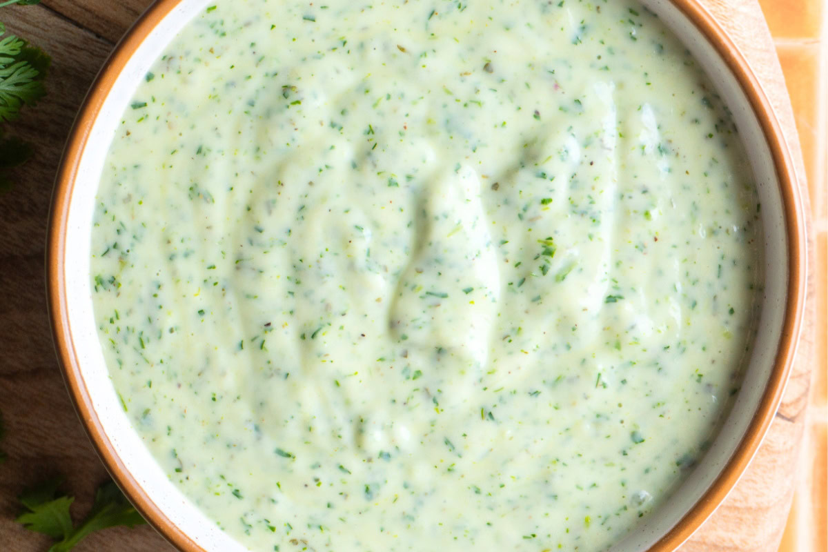 Close up of a bowl of cilantro ranch dressing.
