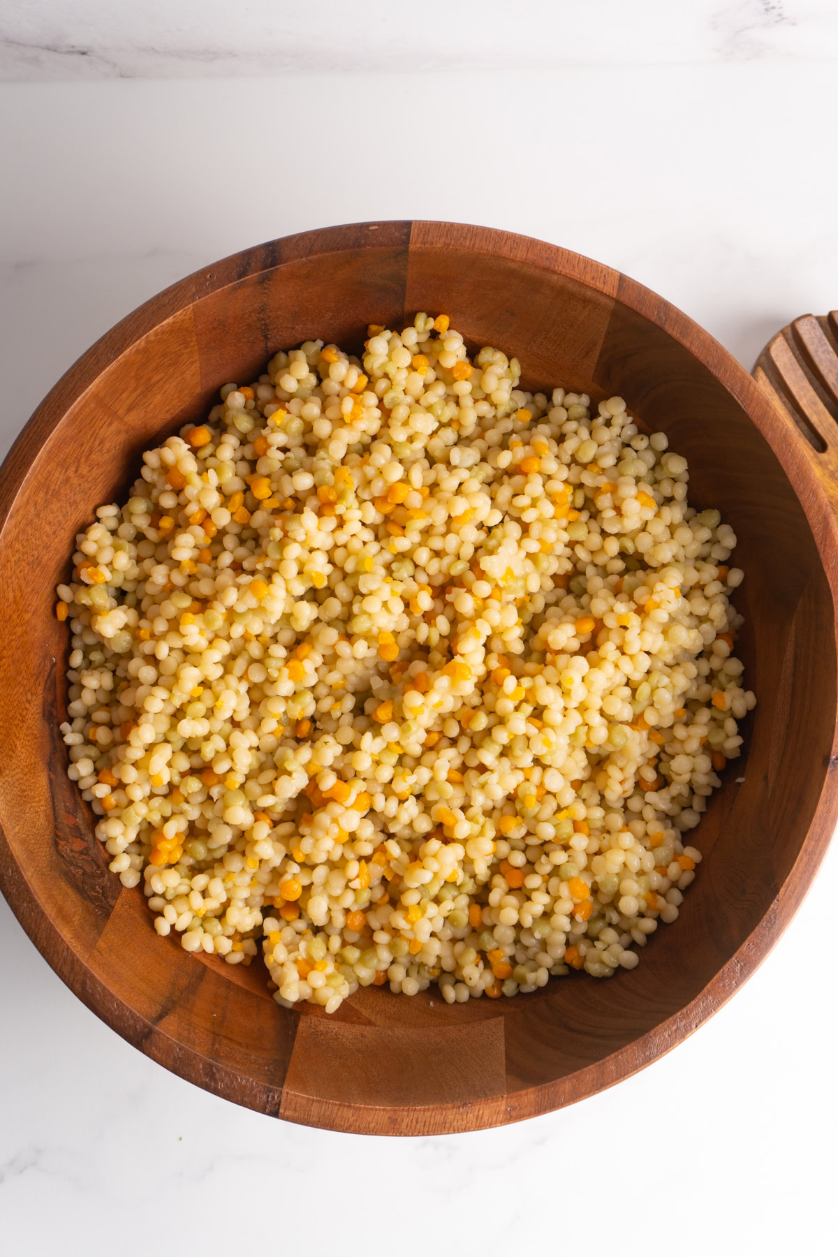 Cooked pearl couscous in a large bowl.