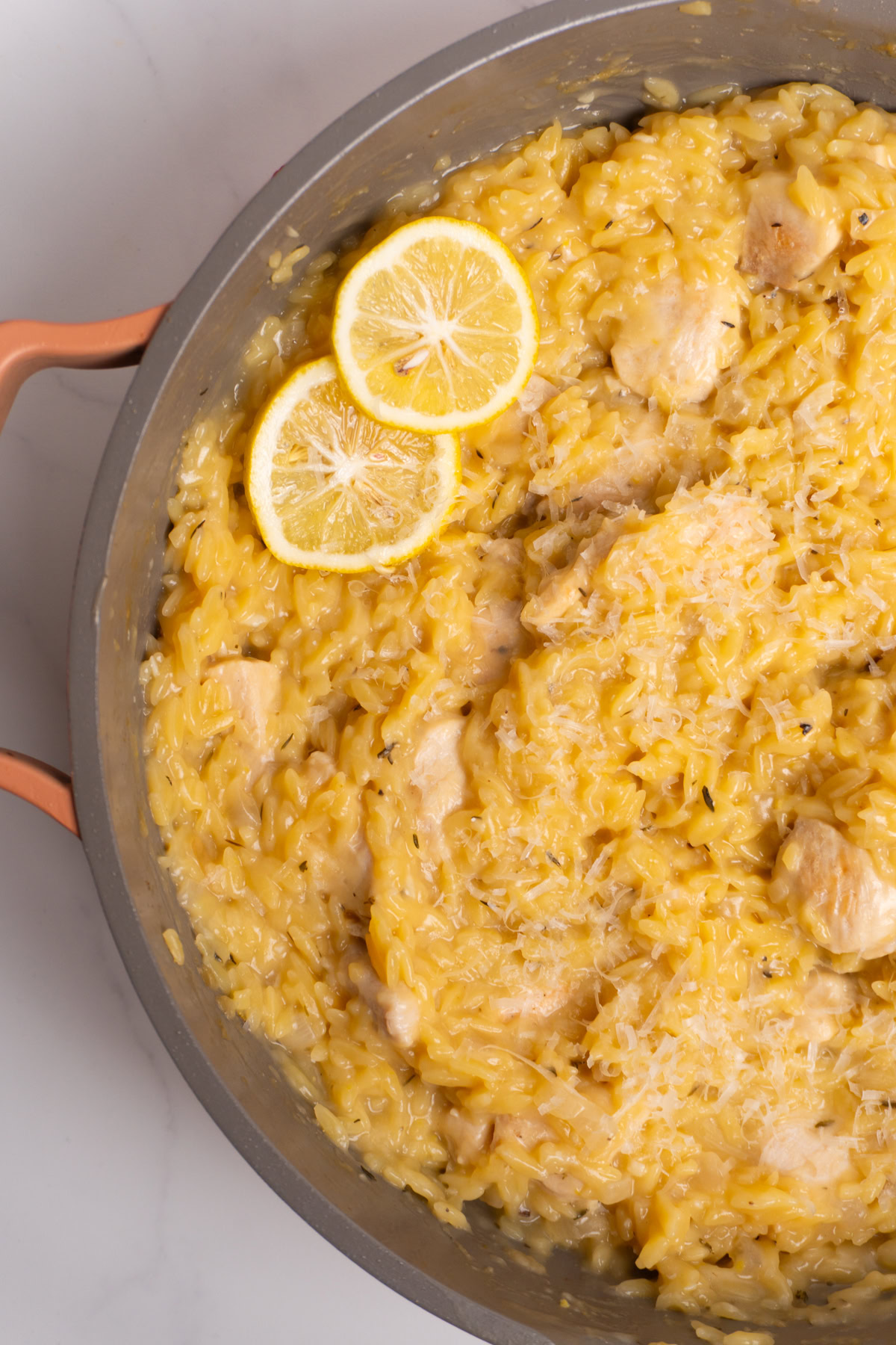 Close up of lemon chicken orzo in a skillet.