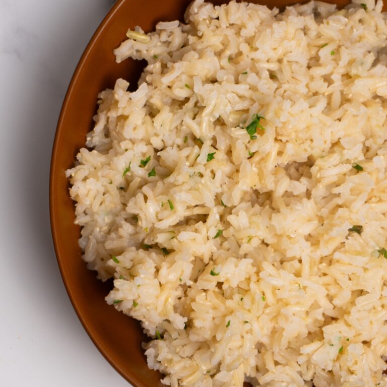 Close up of cilantro lime brown rice in a brown bowl.